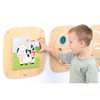 Moje Bambino Cow Puzzle Sensory Wall Panel, child assembling a colorful cow puzzle on a wooden wall-mounted sensory panel
