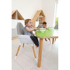 Moje Bambino Curved Horseshoe Table, green curved table with wooden legs, where two young children sit and eat in a bright classroom.