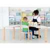 Moje Bambino Curved Horseshoe Table, child and teacher use the white curved classroom table with natural wood edging and legs for a learning activity in a preschool.