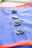 Children's Factory Manual Dexterity Learning Boards - Set of 6, close-up of the blue fabric with silver buttons and red stitching.