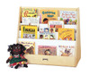 Jonti-Craft Multi Pick-A-Book Stand, wooden book display shelf holding children's books, with a plush doll sitting in front of it.