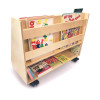 Whitney Brothers Deluxe Two Sided Mobile Book Browser, wooden mobile book display on wheels with multiple shelves filled with children's books.