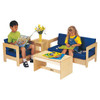 Jonti-Craft Child Living Room Set - Select Color, two children sitting on blue cushioned wooden chairs with armrests, a matching blue cushioned sofa, a wooden coffee table with children's books on it, and a wooden side table with a yellow flower vase.