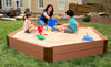 Frame It All Hexagon Wooden Sandbox Kit - 2" Profile - 7' x 8' x 11", children playing and building in a large wooden sandbox with sand toys in a backyard setting. Frame It All Hexagon Wooden Sandbox Kit - 2" Profile - 7' x 8' x 11", children playing and building in a large wooden sandbox with sand toys in a backyard setting.
