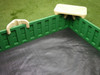 SandLock Plastic Sandbox with Cover 5' x 10', green and white plastic sandbox with a cover, inside view showing the black base and neighboring grass.