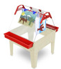 Childbrite Toddler Basic Art Easel - Multiple Colors, a children's art easel with a sturdy white base, red sides, and a transparent acrylic writing surface with colorful clips holding up children's artwork.