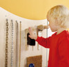 HABA Pro Sensory Learning Wall Activity Panel - Dip A, child touching brushes on sensory wall.