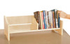 Guidecraft Tabletop Book Browser, wooden book display shelf with books and a child's hand reaching for a book