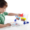 Guidecraft Construction Truck Sort and Match Game, young child playing with a colorful wooden construction truck matching game with different shaped trucks. Guidecraft Construction Truck Sort and Match Game, young child playing with a colorful wooden construction truck matching game with different shaped trucks.