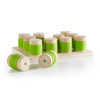 Guidecraft Weight Cylinders for Kids, set of wooden and green plastic stacking weight cylinders on a wooden base with some cylinders stacked and some lying on side.