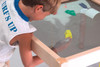 Playscapes Standard Square Magnetic Sand Table, child playing with magnetic toys on the sand surface.