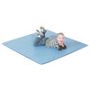 Children's Factory Two Tone Activity Mat - Deep Water/Sky Blue, a young boy lying on a large blue activity mat outdoors, smiling and relaxed.