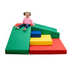 Children's Factory Corner Ridge Soft Play Climber, colorful padded foam climbing structure with a young girl sitting on top Children's Factory Corner Ridge Soft Play Climber, colorful padded foam climbing structure with a young girl sitting on top