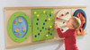 HABA Pro Closures Panel Sensory Wall Activity Panel, young child engaging with the interactive wooden sensory wall with colorful activity panels and textured elements.