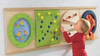 HABA Pro Special Effects Turning Discs Sensory Wall Panel, colorful sensory wall panel with rotating discs and textured surfaces for children.