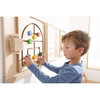 HABA Pro Labyrinth Maze Sensory Wall Panel, young boy playing with a wooden maze puzzle mounted on a wall.