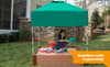 Frame It All Telescoping Square Sandbox Canopy & Cover, a green canopy covering a sandbox with a child playing inside.