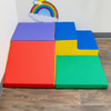 Children's Factory Snuggle Corner Soft Play Set, Rainbow - colorful foam padded play corners for children with vibrant red, purple, blue, yellow, and green sections arranged on wooden floor near wall with rainbow clouds decoration. Children's Factory Snuggle Corner Soft Play Set, Rainbow - colorful foam padded play corners for children with vibrant red, purple, blue, yellow, and green sections arranged on wooden floor near wall with rainbow clouds decoration.