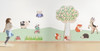 HABA Pro Tree Mirror Interactive Wall Decor, children playing near a wall decorated with a tree, animals, and interactive elements.