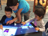 After Mouse Interactive Play Touch Table with Custom Company Logo, children engaging with a touchscreen interactive play table.