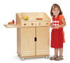 Jonti-Craft TrueModern Play BBQ Grill, a wooden toy grill with a side shelf and a child wearing an apron and smiling.