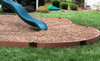 Frame It All Classic Sienna Curved Playground Border 16' - 2" Profile, brown curved plastic border surrounding a playground with mulch and a slide.