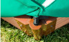 Frame It All Hexagon Sandbox with Collapsible Cover, outdoor sandbox with wooden and plastic components and a green cover, placed on grass.