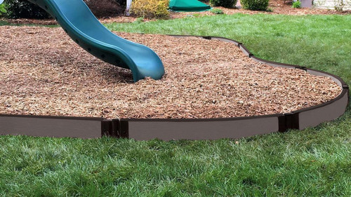 Frame It All Weathered Wood Curved Playground Border Kit 64' - 1" Profile, garden sandbox border with mulch surrounding a playground slide on a lawn.