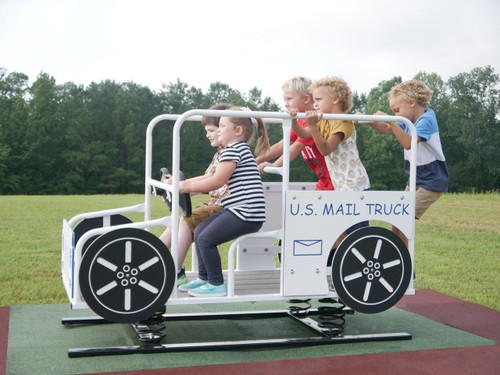 Infinity Playgrounds US Mail Multi Passenger Spring Rider, children riding on a U.S. Mail truck-themed spring rocker in a park.