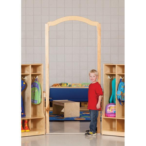 Jonti-Craft Welcome Arch Tall Classroom Divider - KYDZ Suite A or E-height, 84 inches high, in a classroom setting with a young boy standing beside it, surrounded by cubbies with backpacks and shoes.