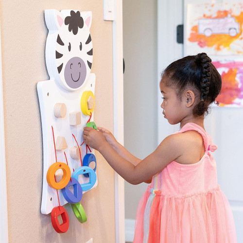SPARK & WOW Zebra Activity Wall Panel, a colorful educational children's toy with wooden blocks and rings on a wall, designed for kids to engage and develop fine motor skills.