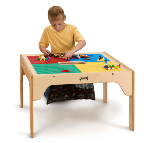Jonti-Craft Wooden LEGO® Square Storage Table, child playing with LEGO bricks on a colorful lego table with storage space underneath.