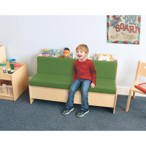 Whitney Brothers Comfy Reading Center Couch, green cushioned kid's sofa with a young boy sitting and smiling in a playroom or classroom setting