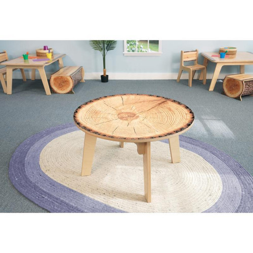 Whitney Brothers Nature View Live Edge Round Table 20" H, wood table with natural live edge top in a room with children’s furniture and a circular rug.