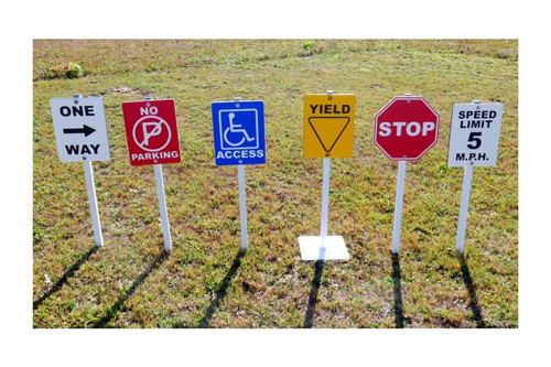 Infinity Playgrounds Playground Traffic Signs For Trike Tracks, set of colorful caution and instruction signs on grass surface.