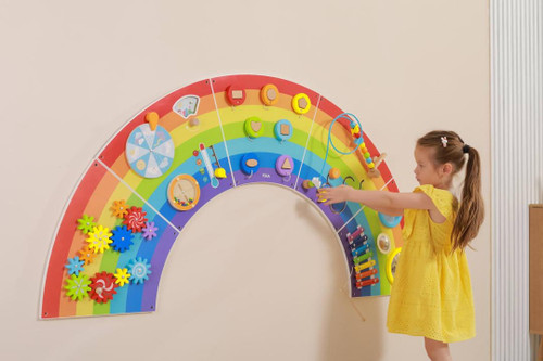 SPARK & WOW Rainbow Activity Wall Panel Toy, a colorful interactive wall toy for children with various educational and sensory activities on a rainbow-shaped panel.