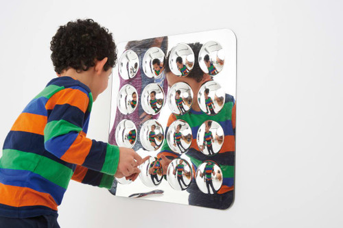 SPARK & WOW Bubble Sensory Mirror -16 Large Bubbles, a child interacting with a mirrored art piece featuring 16 large, round, shiny acrylic bubbles.