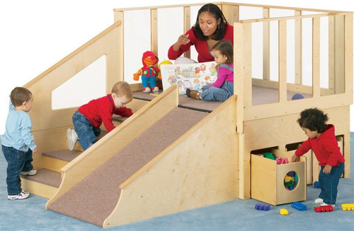 Jonti-Craft Tiny Toddler Loft - 12-24 Months - with Bins, wooden toddler playhouse with ramp, slide, and storage bins, children playing and a caregiver reading a book.