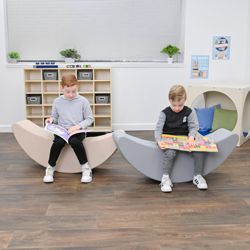 Children's Factory Happy Rocker - Sand, two kids sitting on crescent-shaped rockers in a classroom.