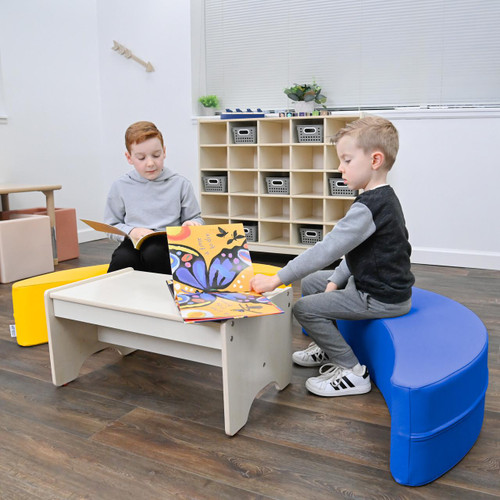 Children's Factory Happy Rocker - Blue, a children's blue curved rocking toy used for play and comfort, in a modern indoor playroom.