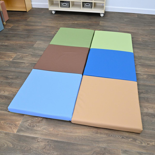 Children's Factory Tent Box Play Mats, Woodland - Set of 2, colorful foam play mats in green, brown, blue, and beige arranged on a wooden floor.