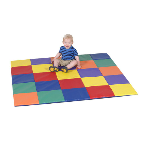 Children's Factory Patchwork Activity Play Mat, Rainbow, colorful foam play mat with a young child sitting on it, enjoying playtime.