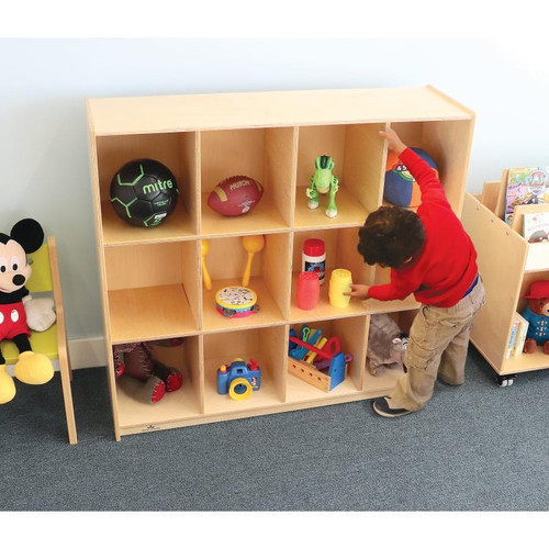 Whitney Brothers 12 Cubby Backpack Storage Cabinet, wooden cubby storage unit filled with children's toys and used in a classroom or playroom.
