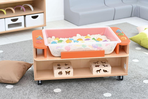 Moje Bambino Mobile Sensory Cart, a children's sensory play cart with sand and colorful toys on a wooden stand with wheels in a playroom.