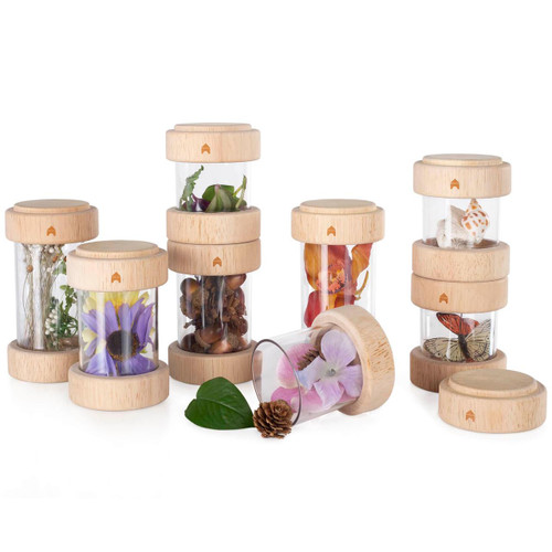 Guidecraft Clear Treasure Tubes Sensory Set, set of transparent tubes with wooden lids containing various natural and colorful objects for sensory play.
