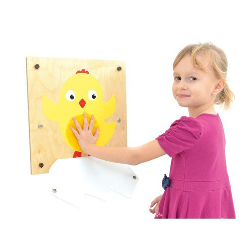 Moje Bambino Chicken Fine Motor Skills Wall Panel, a wooden wall panel featuring a cute yellow chick with movable parts for fine motor skill development, interacted with by a young girl in a pink dress.