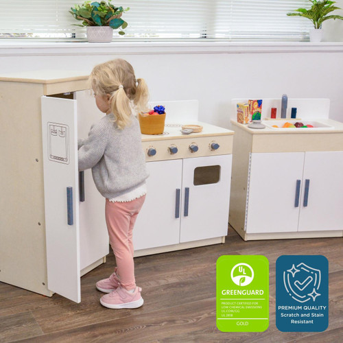Angeles Play Kitchen Set 3-Pieces - RTA, child playing with a toy kitchen set in a playroom with potted plants on the windowsill.