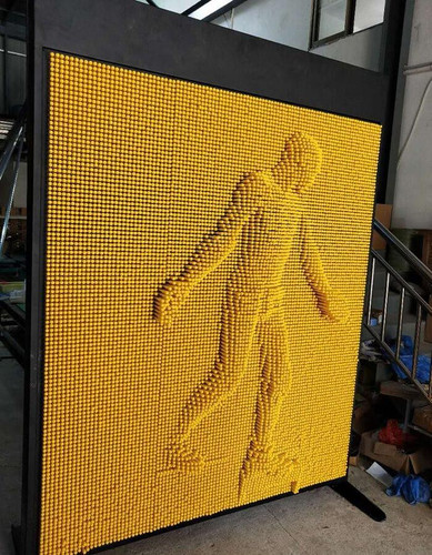LiteZilla Clone Box Giant Pin Wall STEM Activity, a large yellow pin wall featuring a pixelated human figure design.