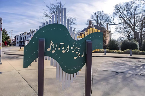 Freenotes Swirl Outdoor Chimes, decorative musical wind chimes mounted on poles in an outdoor setting