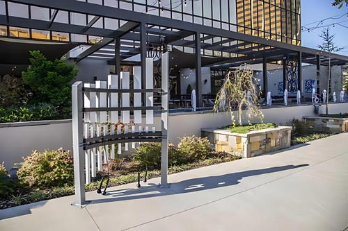 Freenotes Titan Tines Tuning Forks, outdoor musical instrument setup with large metal tuning forks displayed on a modern urban patio.